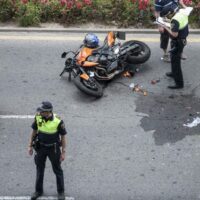 Police Addressing Motorcycle Accident Stock Photo