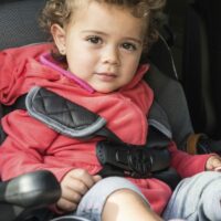 Young Baby Sitting In A Car Seat Stock Photo