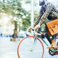 Man Riding His Bicycle In The City Stock Photo