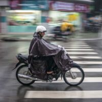 Man Riding Motorcycle In The Rain Stock Photo
