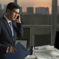 Insurance Adjuster On The Phone In His Office Stock Photo