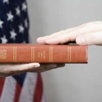 Hand On Holy Bible Stock Photo | Car Accident Deposition