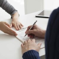 Person Signing Document Stock Photo | Car Accident Settlement | Personal Injury