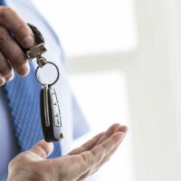Car Leaser Given Keys By Dealer Stock Photo