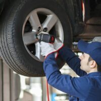 Mechanic Changing A Tire Stock Photo