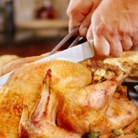 Man Cutting Thanksgiving Turkey Stock Photo
