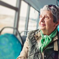Elderly Woman Riding A Public Bus Stock Photo