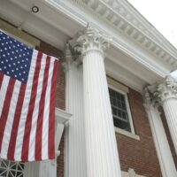 American Flag Traditional Town Hall Building Stock Photo