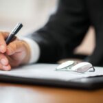 Businessman Signing Document Stock Photo