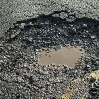 Closeup Of A Large Pothole On A City Street